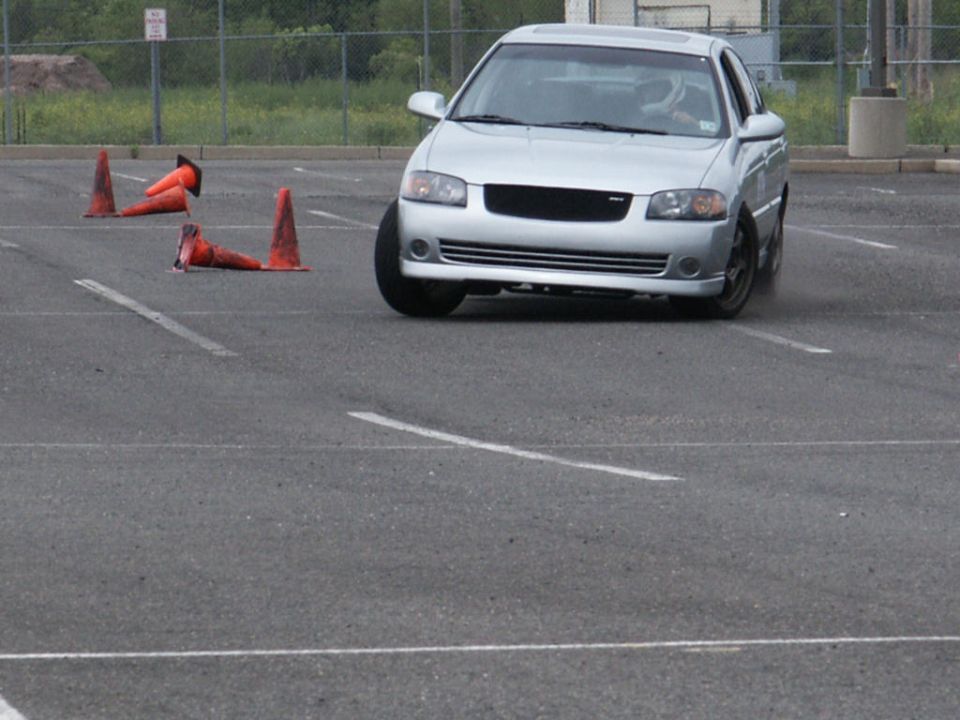 Silver sedan navigating a cone course in a parking lot