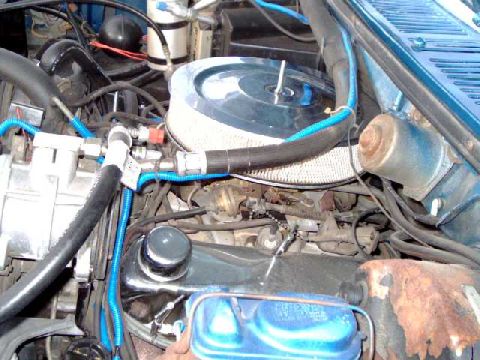 1984 Ford Bronco - driver's-side view of engine. The carb is set way back under the cowl, angled back, and 2" off-center