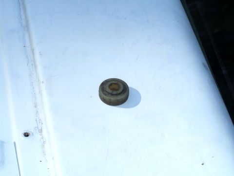 1979 Ford Bronco - Close-up of a rubber bumper part on a white surface, with Supermotors.net logo.