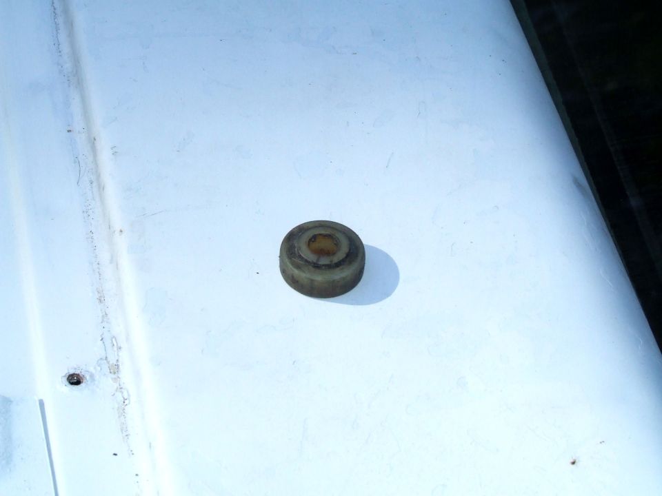 Rubber bumper part on a white surface. Supermotors.net logo visible