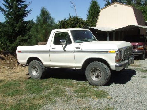 1979 Ford Bronco - A white 1978 Ford Bronco is parked outside on a sunny day, with a barn and trees visible.