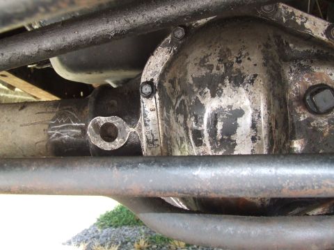 1979 Ford Bronco - Differential housing and axle tube detail, showing some wear and markings.