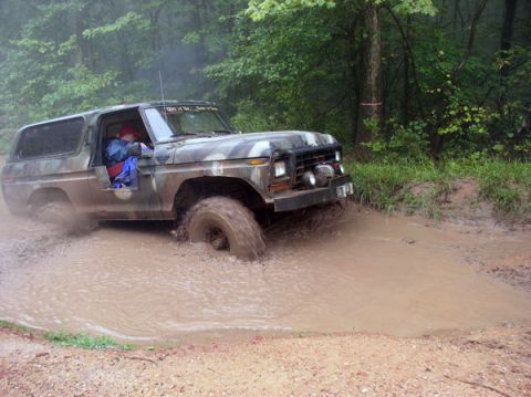 1988 Ford Bronco - This 1978 Ford Bronco is shown off-road, splashing through a deep mud puddle.