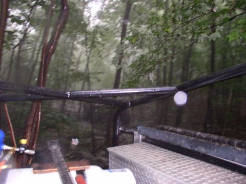 1988 Ford Bronco - Driving through a wooded area during what appears to be rainy weather.