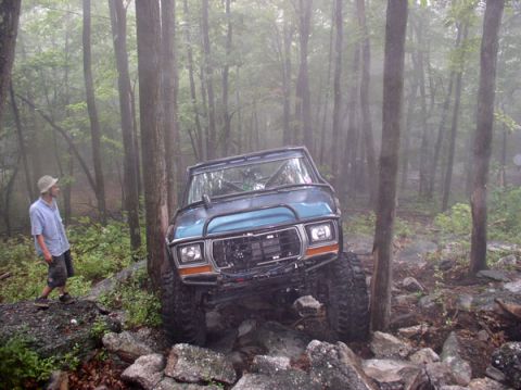 1988 Ford Bronco - This modified 1978 Ford Bronco is shown navigating a challenging rocky trail in a wooded area.