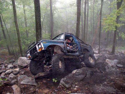 1988 Ford Bronco - Blue full-size Ford Bronco built as a trail rig with doors removed, an internal roll cage, cut fenders and a lifted solid-axle suspension o…