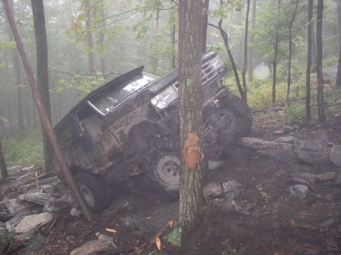 1988 Ford Bronco - This 1988 Ford Bronco is stuck on a challenging off-road trail with steep inclines and large rocks.