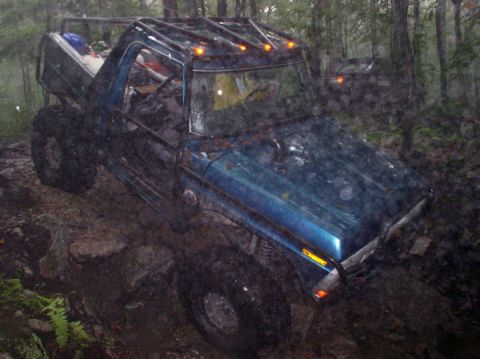 1988 Ford Bronco - Off-roading in a modified 1988 Ford Bronco on a challenging forest trail.