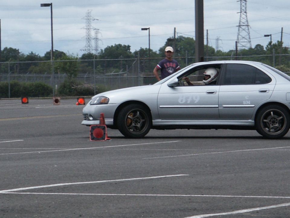 Silver sedan with racing number 879 on the side, seen from the side