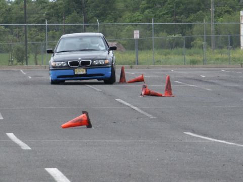 2001 Mercury Grand Marquis - BMW 3 Series with a custom blue front bumper navigates a cone course in a parking lot.