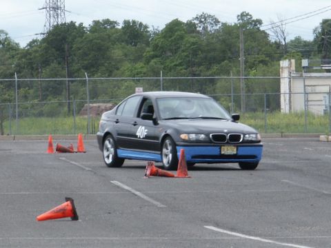 2001 Mercury Grand Marquis - A BMW 3 Series sedan is shown on a paved lot, maneuvering around traffic cones during what appears to be a driving event.