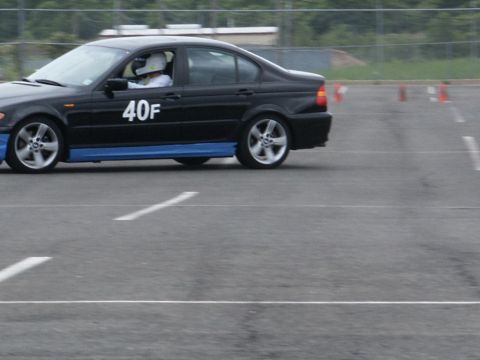 2001 Mercury Grand Marquis - A black sedan with blue accents and the number '40F' visible on its door drives on a track.