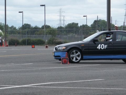 2001 Mercury Grand Marquis - A black sedan with blue racing stripes and the number 40F is seen on a track with orange cones.