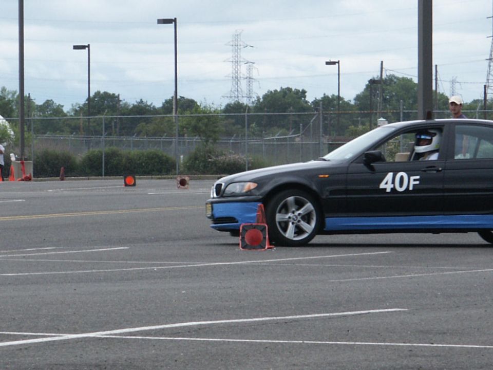 Black sedan with blue trim and racing number 40F on a track