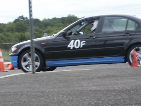 2001 Mercury Grand Marquis - Sedan with racing numbers and blue trim on a track with cones.
