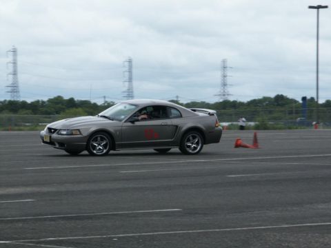 2001 Mercury Grand Marquis - A gray coupe with red decals on its side navigates a course marked by orange cones.