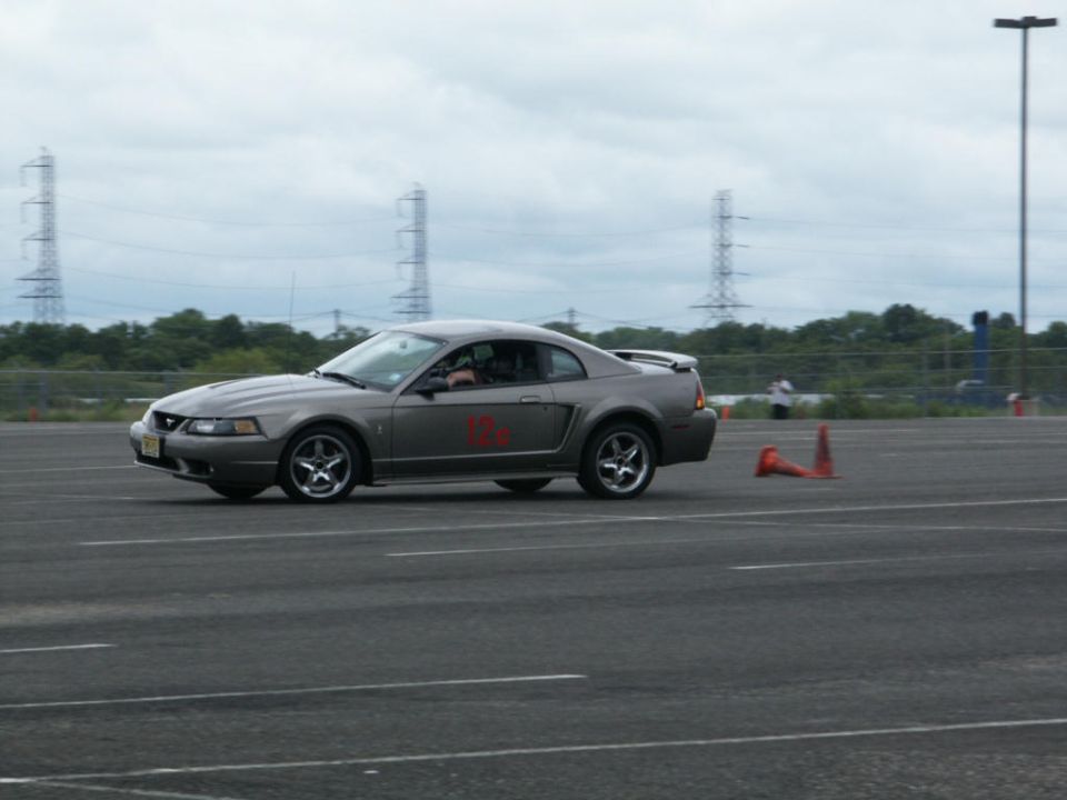 Gray coupe with red decals on the side, seen from a 3/4 front angle