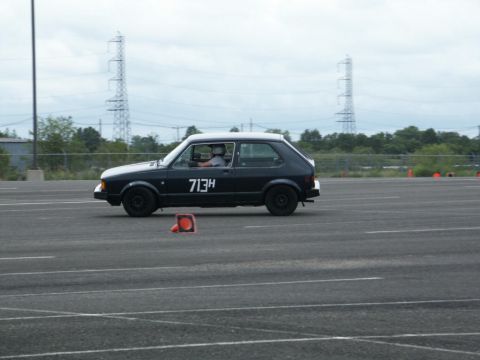 2001 Mercury Grand Marquis - A black hatchback with a white roof is seen on a track, marked with the number 713H.