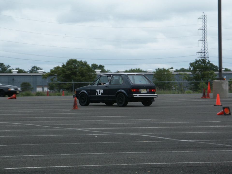 Black Volkswagen Golf Mk1 with number 713H on the door, seen from the rear