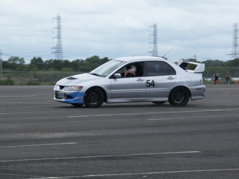 2001 Mercury Grand Marquis - Mitsubishi Lancer Evolution VIII with racing modifications on a paved track.