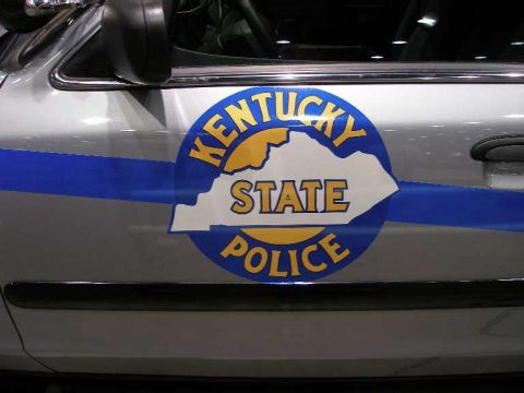 1998 Ford Crown Victoria - Close-up of the front driver's-side door of a silver Ford Crown Victoria showing the Kentucky State Police decal, a round blue-and-gold emb…