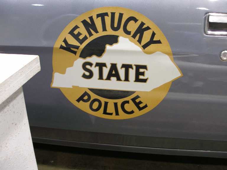 Kentucky State Police gold door decal on a gray vintage police car door