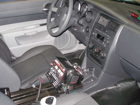 1998 Ford Crown Victoria - Interior view of a vehicle from the passenger side showing the gray and black dashboard, steering wheel, center stack with radio and climat…