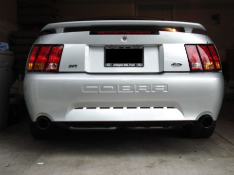 1998 Ford Taurus - Rear view of a silver Ford Mustang Cobra SVT, dual exhaust and distinctive taillights.