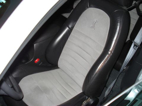 1998 Ford Taurus - Close-up of car's interior, highlighting the distinctive black and grey seats with a prominent Cobra logo.