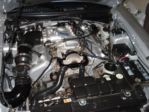 1998 Ford Taurus - Close-up view of a car's engine bay, showing various components and wiring.