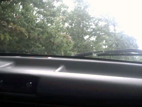 1996 Ford Bronco - View from the driver's seat through the windshield, with trees visible beyond the dashboard.