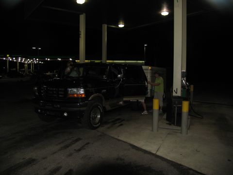 1995 Ford C-350 (Centurion Conversions) - 1995 Ford C-350 (Centurion Conversions) at a gas station at night, with a trailer attached.