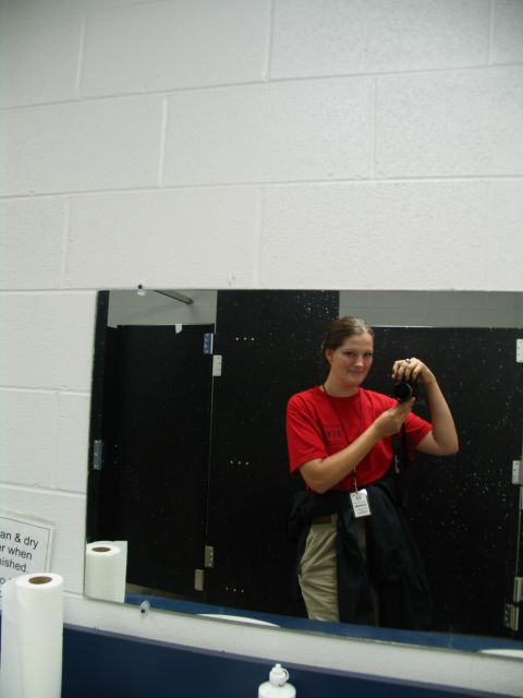 1995 Ford C-350 (Centurion Conversions) - A woman captures her reflection in a restroom mirror while holding a camera.