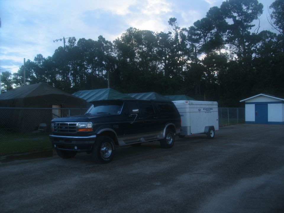 Dark blue Ford Bronco towing a white trailer