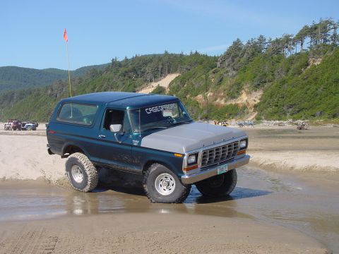 1979 Ford Bronco - This 1979 Ford Bronco navigates a wet sandy beach with off-road tires and a two-tone paint scheme.