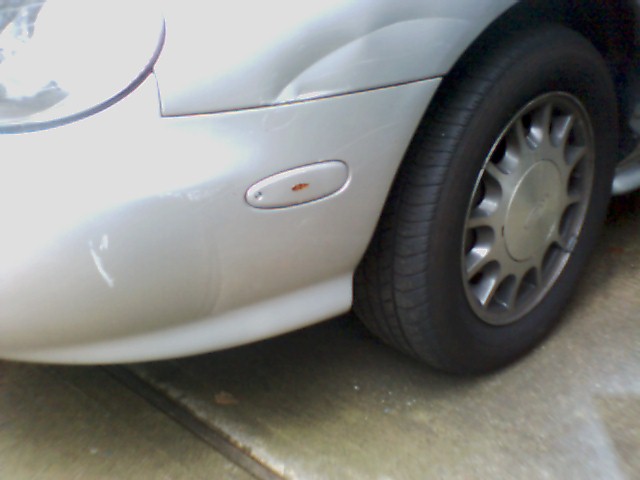 1998 Ford Taurus front fender, headlight area, and wheel
