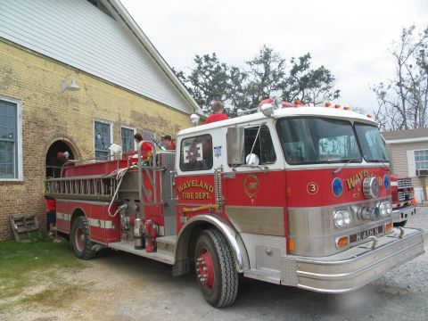 1995 Ford C-350 (Centurion Conversions) - A fire truck with 'Waveland Fire Dept.' markings is parked next to a building, with another vehicle in the background.