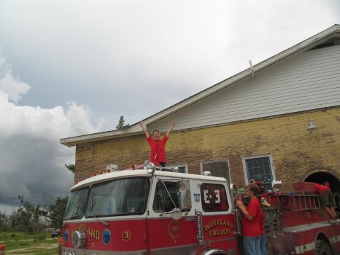 1995 Ford C-350 (Centurion Conversions) - A fire truck with 'Waveland Fire Dept.' text is visible, with people interacting around it.
