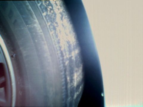 1998 Ford Taurus - Close-up view of a car's tire and fender area.