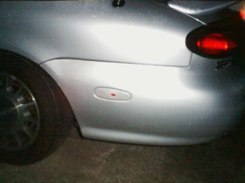 1998 Ford Taurus - Rear side view of a silver car, highlighting the taillight and fender marker.