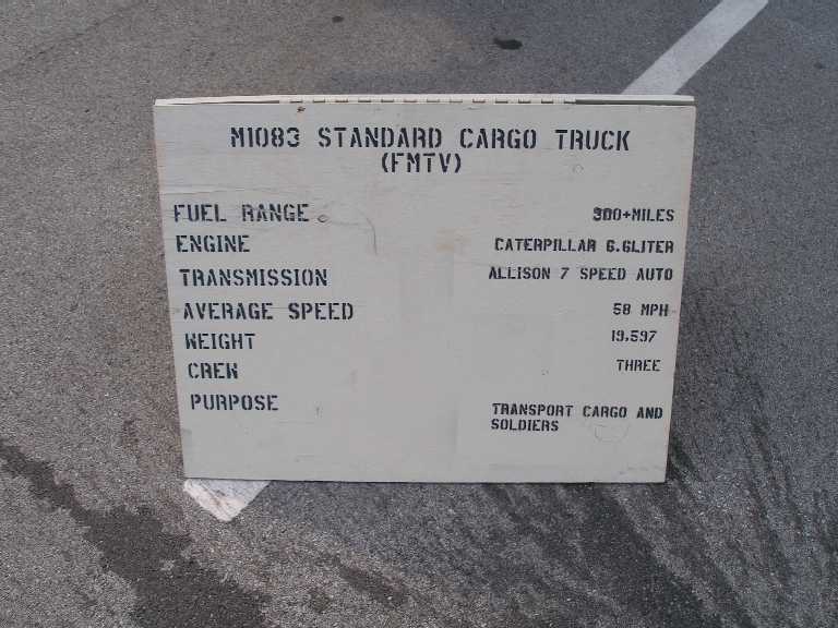 Spec placard for the M1083 FMTV standard cargo truck listing engine, transmission and crew details