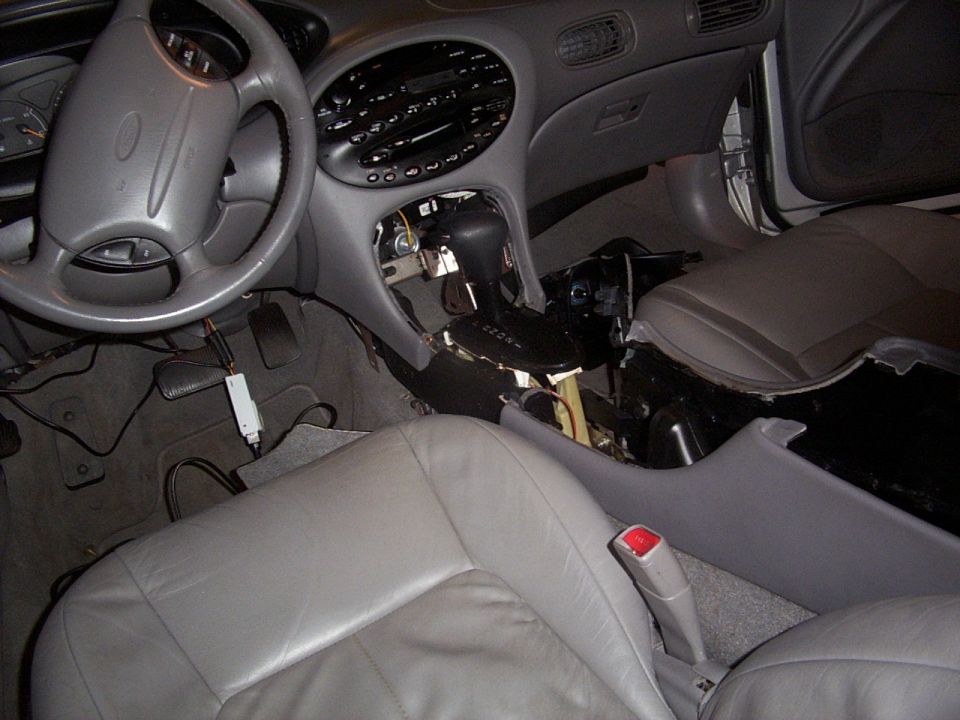 here is where i started to take apart the console, it may seem like i wouldn't have to go through all of that but i did because of certian little screw that were underneath and i had to get to them.  I had to take out the entire interior manifold of the arm rest, to be able to fit the changer in there.