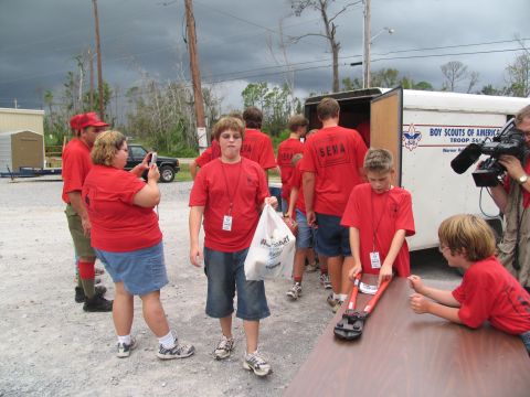 1995 Ford C-350 (Centurion Conversions) - Group of people, likely Boy Scouts, gathered near a trailer with 'Boy Scouts of America' visible on the side.
