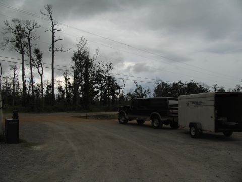 1995 Ford C-350 (Centurion Conversions) - A black van tows a white trailer, possibly for disaster relief, under a cloudy sky.