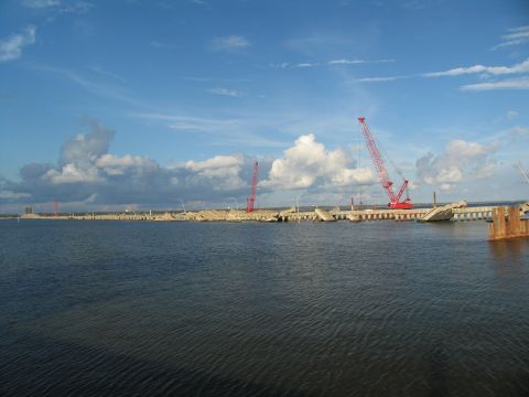 1995 Ford C-350 (Centurion Conversions) - Construction cranes are visible at a damaged bridge site over the water.