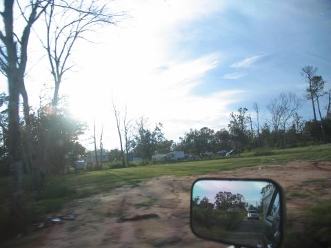 1995 Ford C-350 (Centurion Conversions) - Rural landscape with trees and a dirt road, viewed from inside a vehicle.