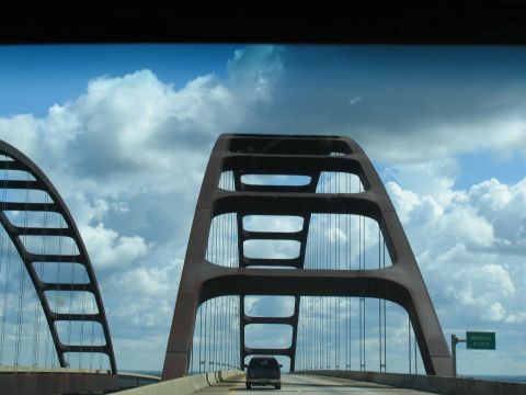 1995 Ford C-350 (Centurion Conversions) - A truck travels across a large bridge with distinctive arch structures.