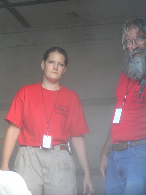 1995 Ford C-350 (Centurion Conversions) - Two individuals are pictured wearing red SEMA t-shirts and lanyards with identification badges.