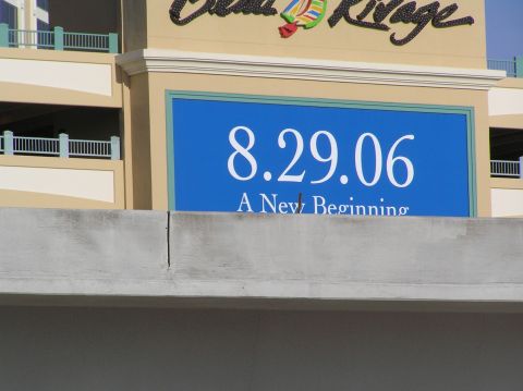 1995 Ford C-350 (Centurion Conversions) - A sign on a building displays the date 8.29.06 and the phrase 'A New Beginning'.