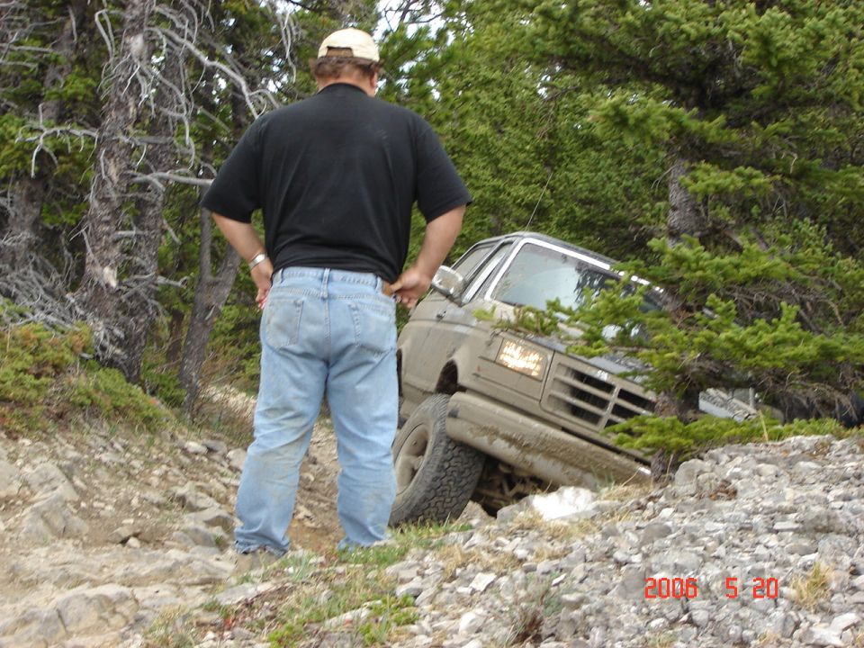 Tan 1995 Ford Bronco on a rocky trail, front 3/4 view